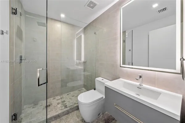 a bathroom with a sink toilet and shower