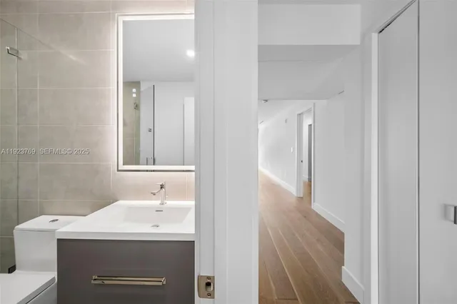 a bathroom with a sink a mirror and a shower