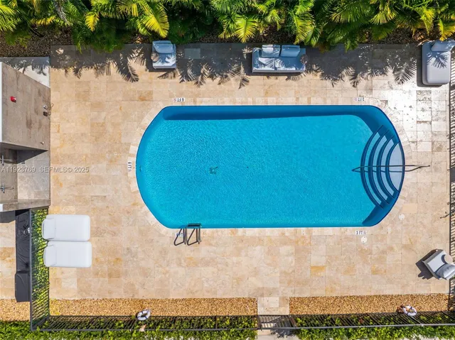 an aerial view of a house with a swimming pool