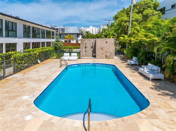 a view of swimming pool with outdoor seating and plants