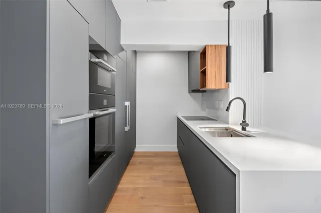 a kitchen with stainless steel appliances granite countertop a sink and a refrigerator