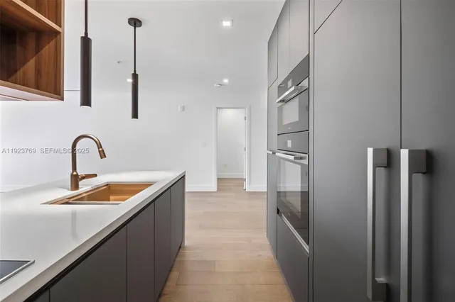 a kitchen with stainless steel appliances granite countertop a refrigerator and a sink