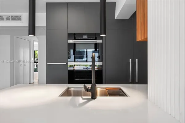 a kitchen with a refrigerator and microwave