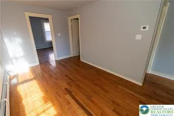 a view of hallway with wooden floor