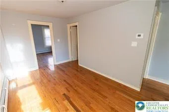 a view of hallway with wooden floor