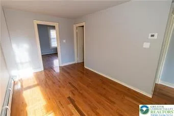 a view of hallway with wooden floor