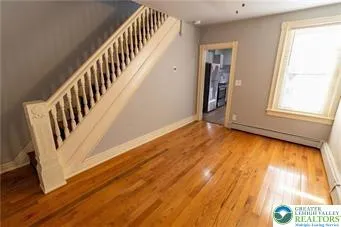 a view of an entryway with wooden floor