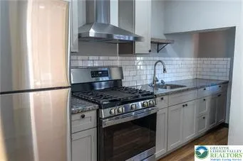 a stove top oven sitting inside of a kitchen