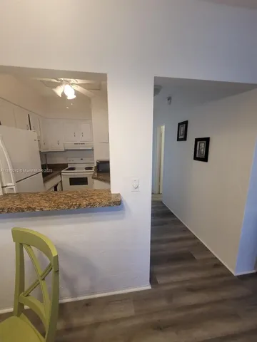 a view of kitchen with granite countertop wall and sink