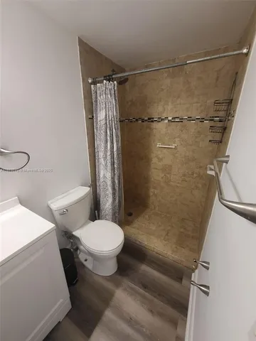 a bathroom with a toilet and a shower