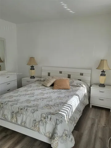 a bedroom with double bed and next to a lamp
