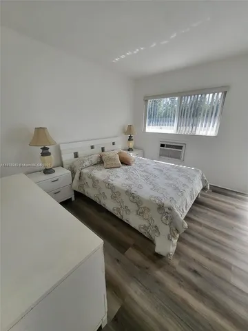 a bedroom with bed and window