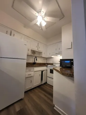 a kitchen with a white cabinets and white appliances