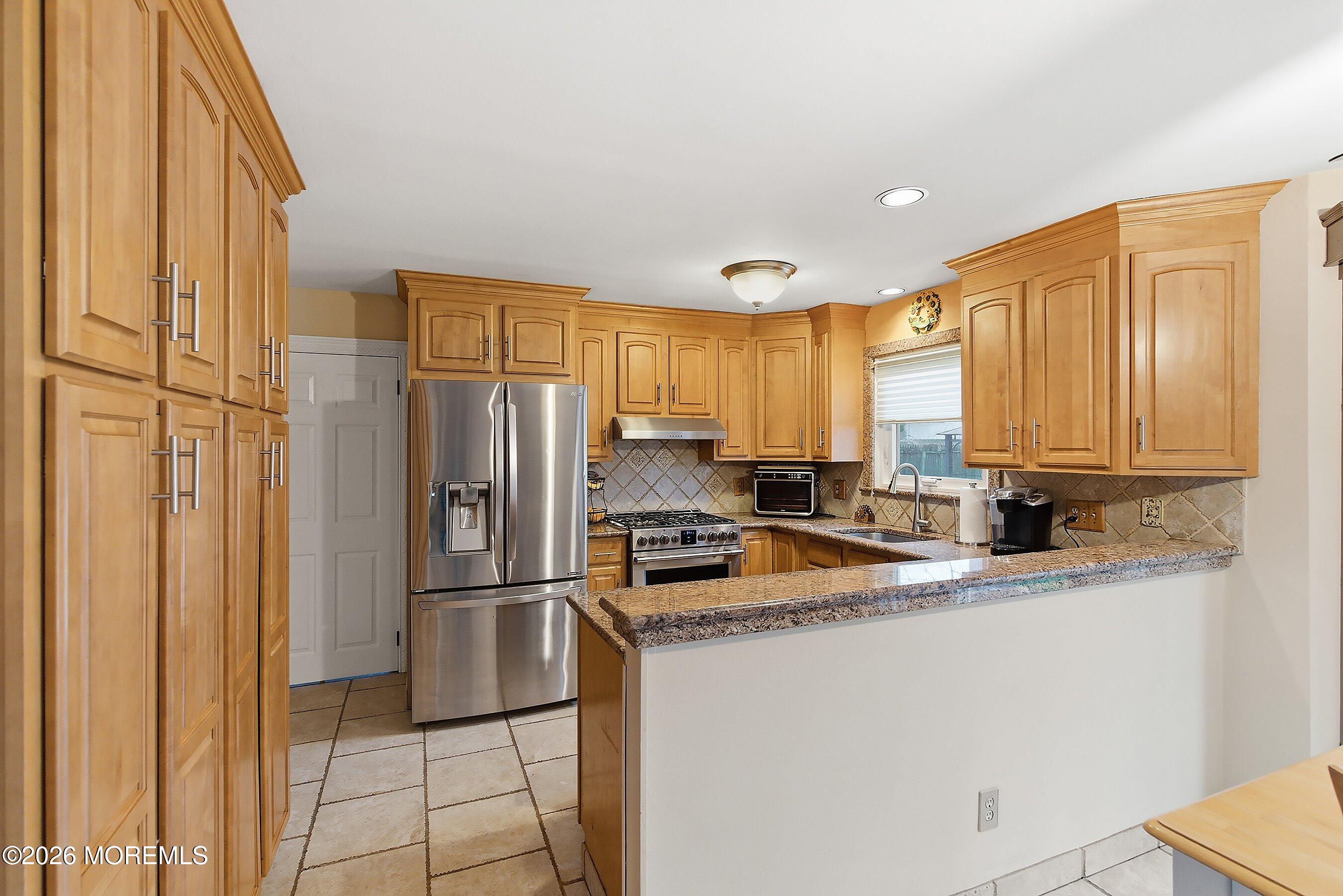 7 Metedeconk Road Howell, NJ 07731 - Photo 15 of 44 a kitchen with granite countertop a refrigerator and a sink