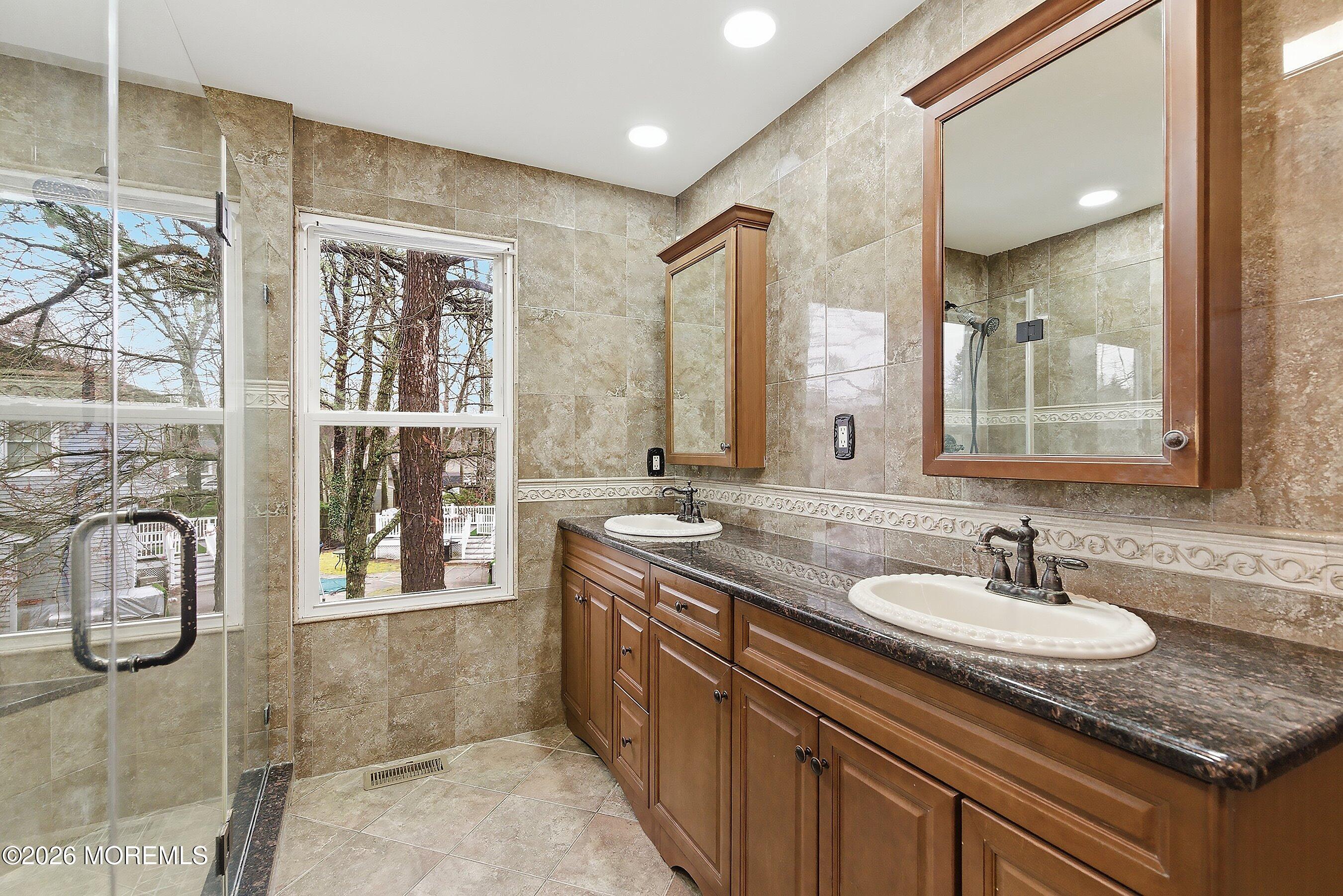 7 Metedeconk Road Howell, NJ 07731 - Photo 27 of 44 a bathroom with a granite countertop sink a mirror and a shower