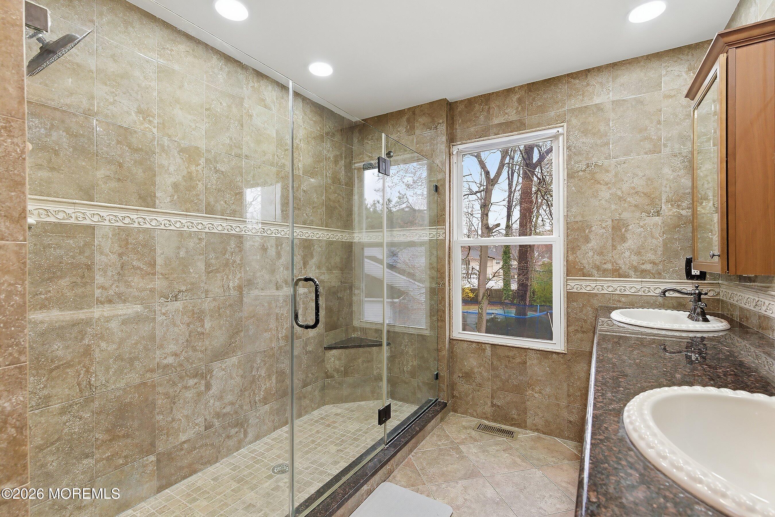 7 Metedeconk Road Howell, NJ 07731 - Photo 29 of 44 a bathroom with a granite countertop sink a mirror and shower