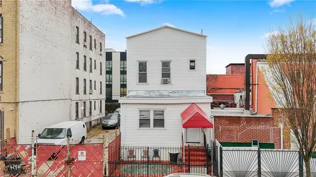 aerial view of multiple houses with a yard