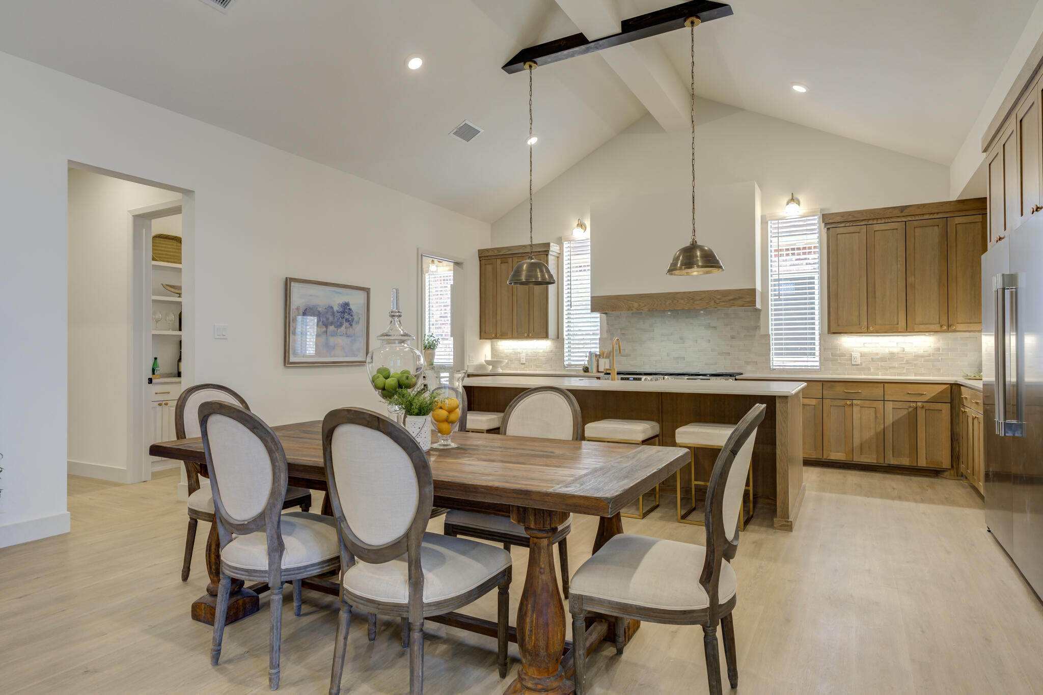 3809 126th Street Lubbock, TX 79423 - Photo 14 of 58 a kitchen with granite countertop a table chairs stove a sink and a refrigerator