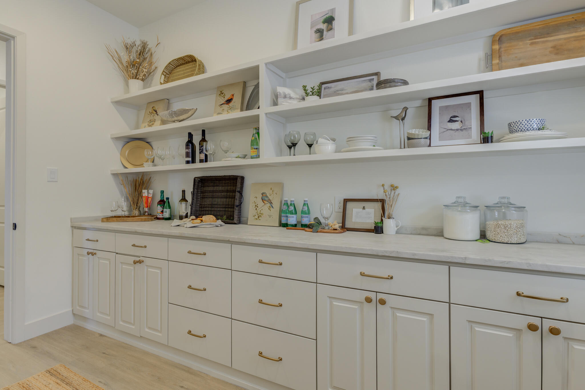 3809 126th Street Lubbock, TX 79423 - Photo 27 of 58 a kitchen with white cabinets and a wooden floor
