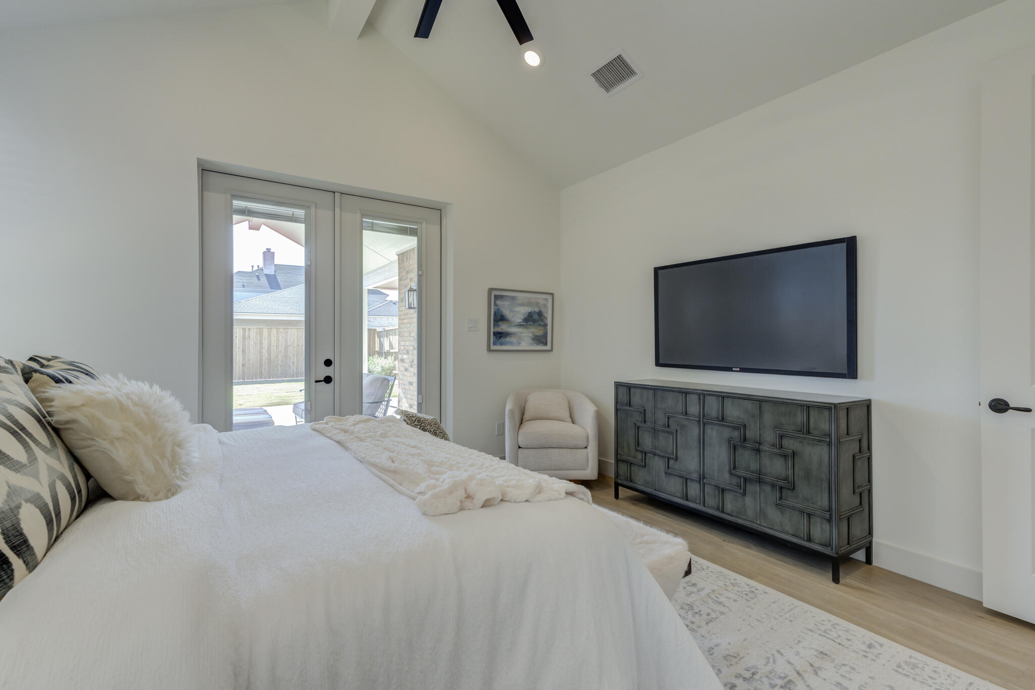 3809 126th Street Lubbock, TX 79423 - Photo 34 of 58 a bedroom with a bed and a flat screen tv