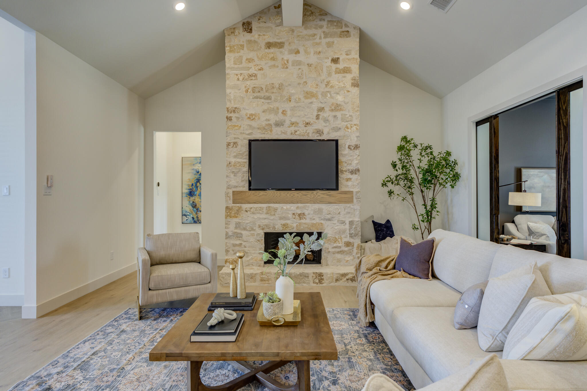 3809 126th Street Lubbock, TX 79423 - Photo 4 of 58 a living room with furniture a fireplace and a flat screen tv