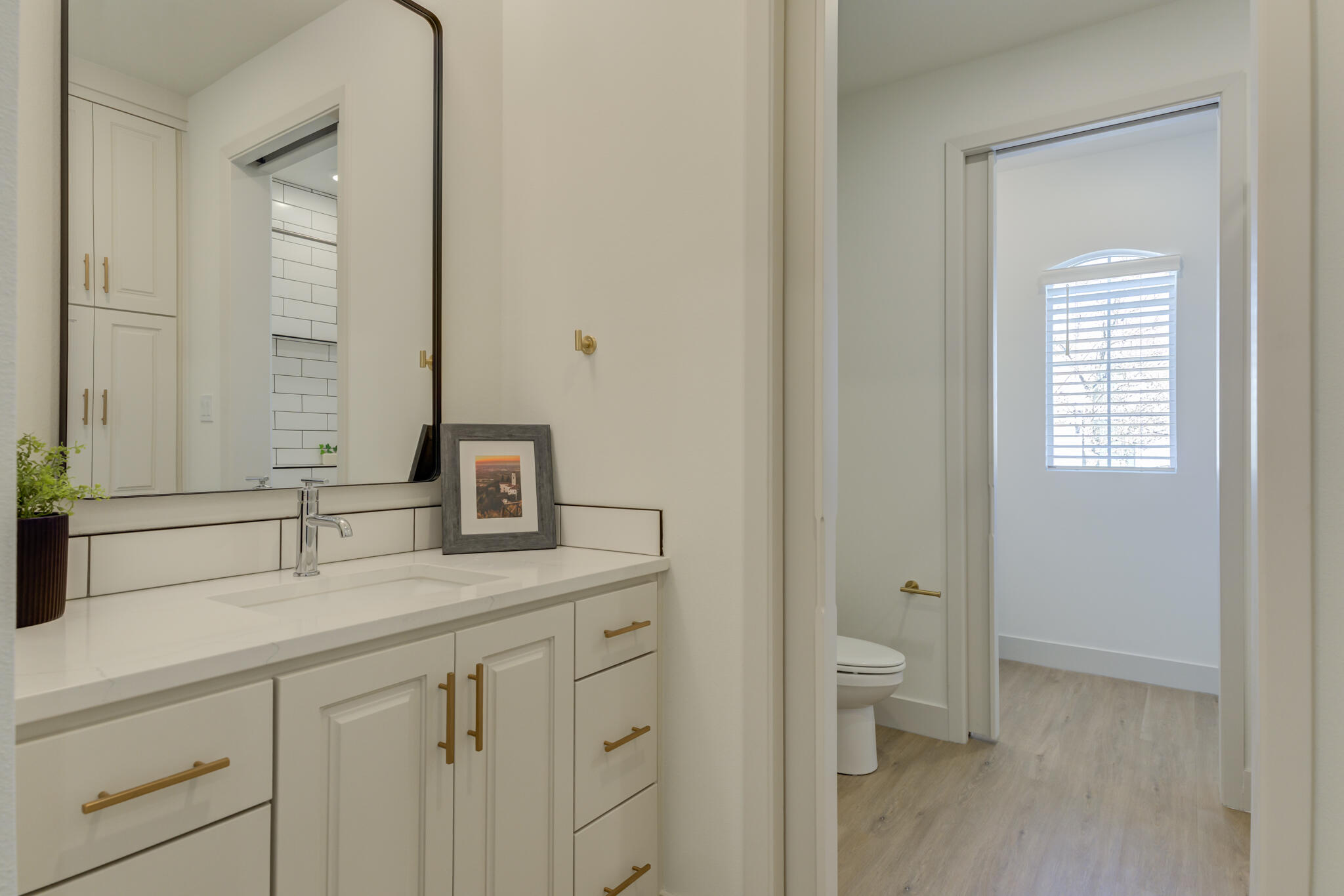3809 126th Street Lubbock, TX 79423 - Photo 44 of 58 a bathroom with a sink a toilet and a mirror