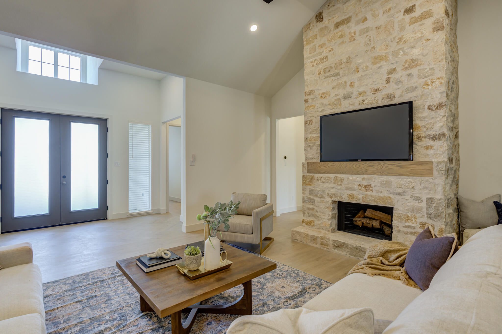 3809 126th Street Lubbock, TX 79423 - Photo 9 of 58 a living room with furniture a fireplace and a flat screen tv