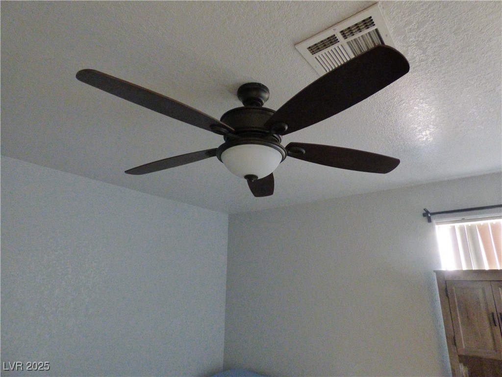 5044 South Rainbow Boulevard, Unit 106 Las Vegas, NV 89118 - Photo 13 of 18 Detailed view of a textured ceiling and a ceiling fan