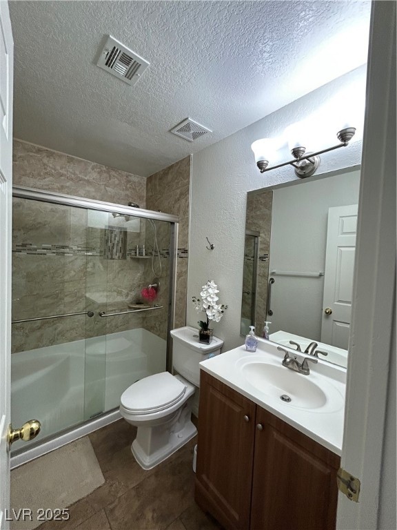 5044 South Rainbow Boulevard, Unit 106 Las Vegas, NV 89118 - Photo 10 of 18 Primary bathroom featuring a textured ceiling, vanity, a stall shower, and a textured wall