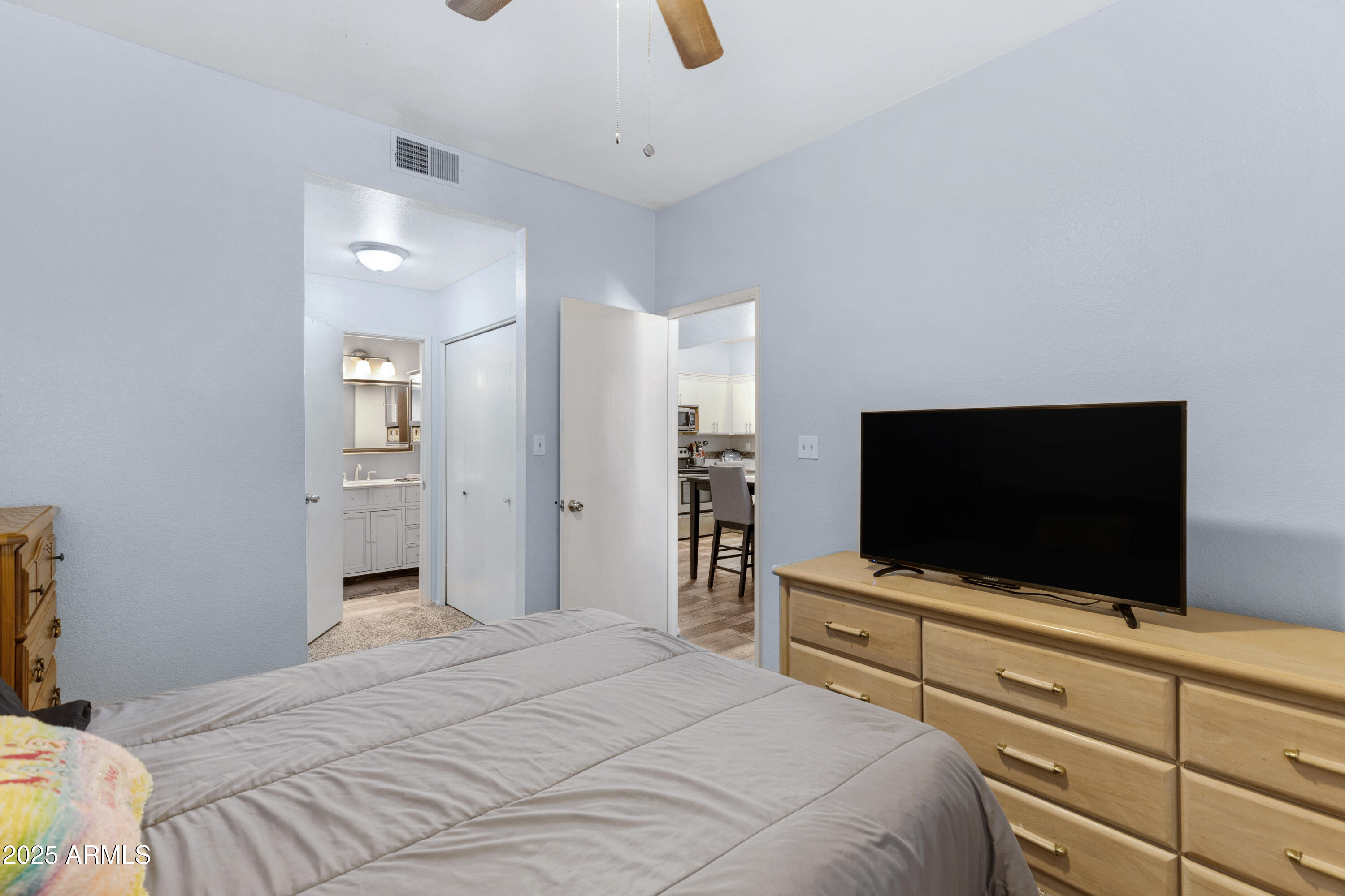 1126 West Elliot Road, Unit 1017 Chandler, AZ 85224 - Photo 9 of 17 a bedroom with a bed and a flat screen tv