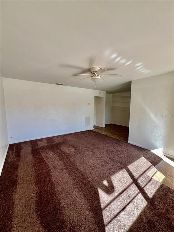 2075 Howell Branch Road, Unit 109 Maitland, FL 32751 - Photo 3 of 11 a view of a big room with wooden floor and closet