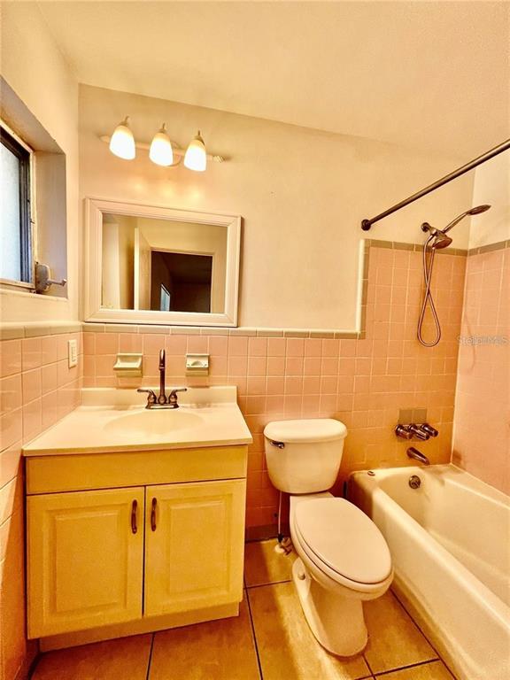 2075 Howell Branch Road, Unit 109 Maitland, FL 32751 - Photo 10 of 11 a bathroom with a granite countertop toilet sink and mirror