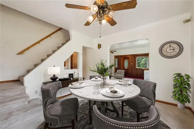 a dining room with furniture and a floor to ceiling window