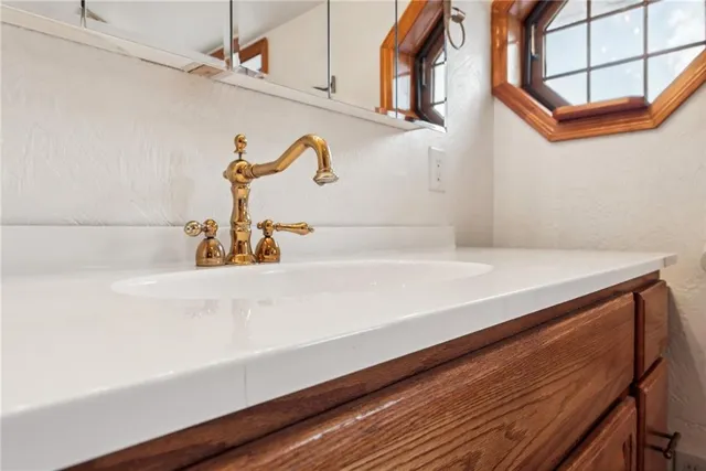 a bathroom with a tub sink and mirror