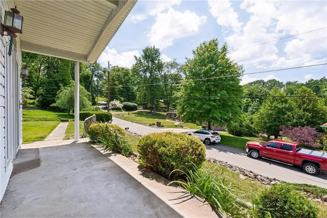 a view of a garden with cars