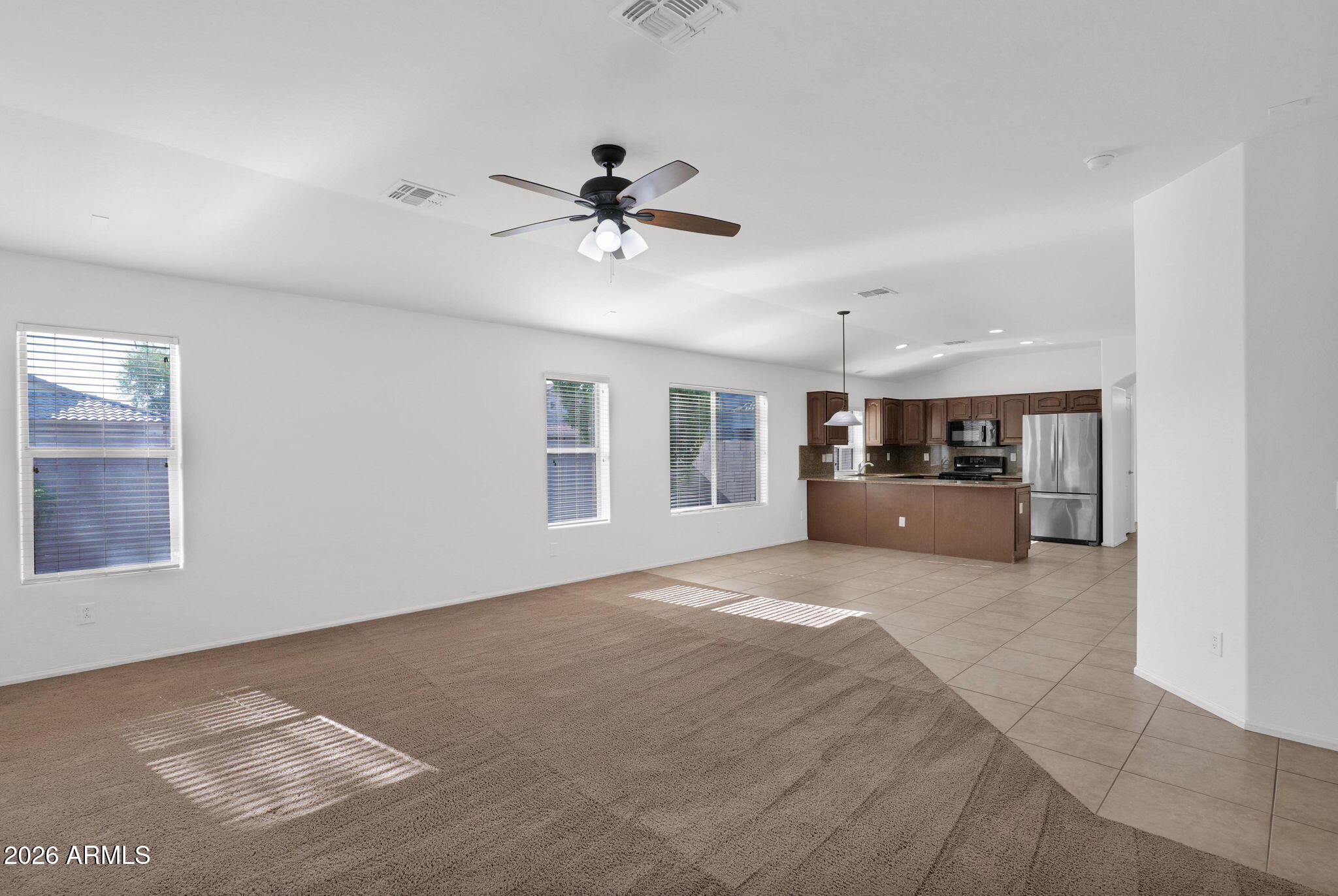 2730 East Dry Wood Road Phoenix, AZ 85024 - Photo 11 of 33 a big room with chandelier fan and windows