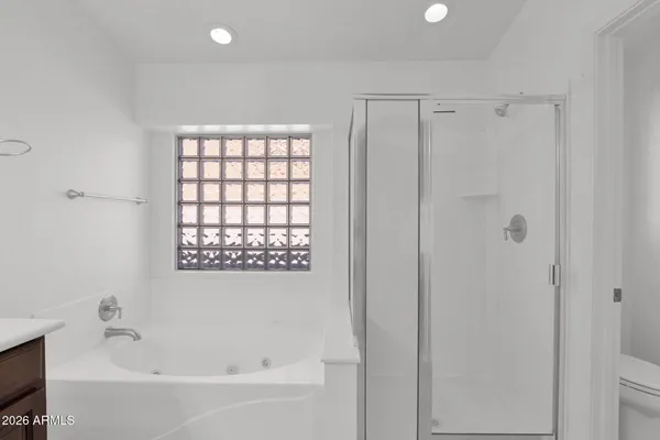 a white bath tub sitting next to a shower
