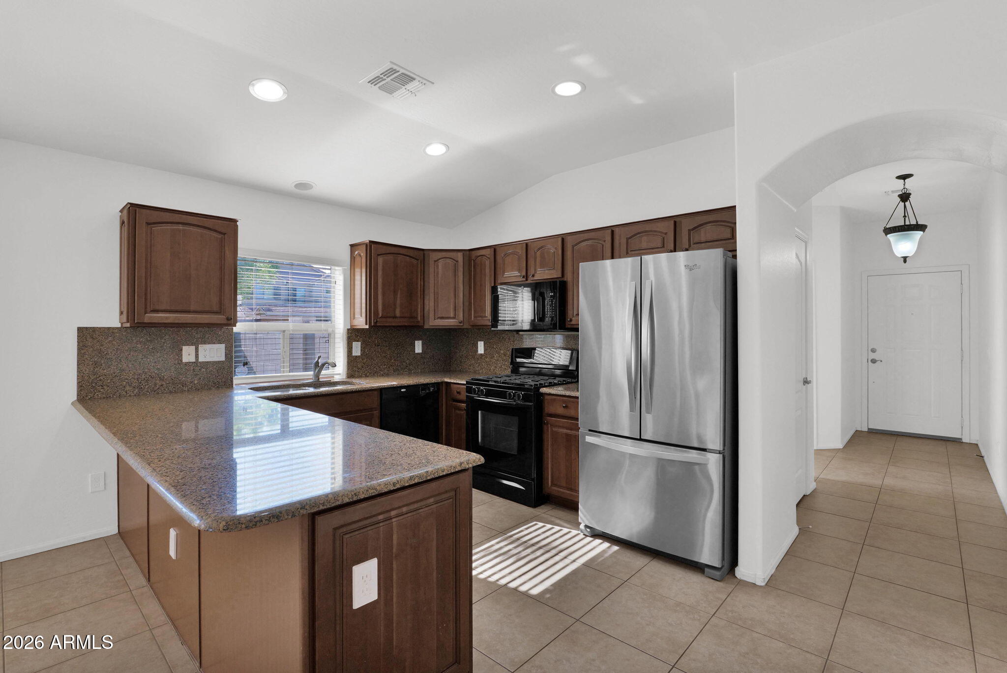 2730 East Dry Wood Road Phoenix, AZ 85024 - Photo 3 of 33 a kitchen with granite countertop a refrigerator and a stove top oven
