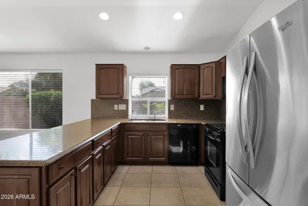 a kitchen with stainless steel appliances granite countertop a refrigerator and a sink