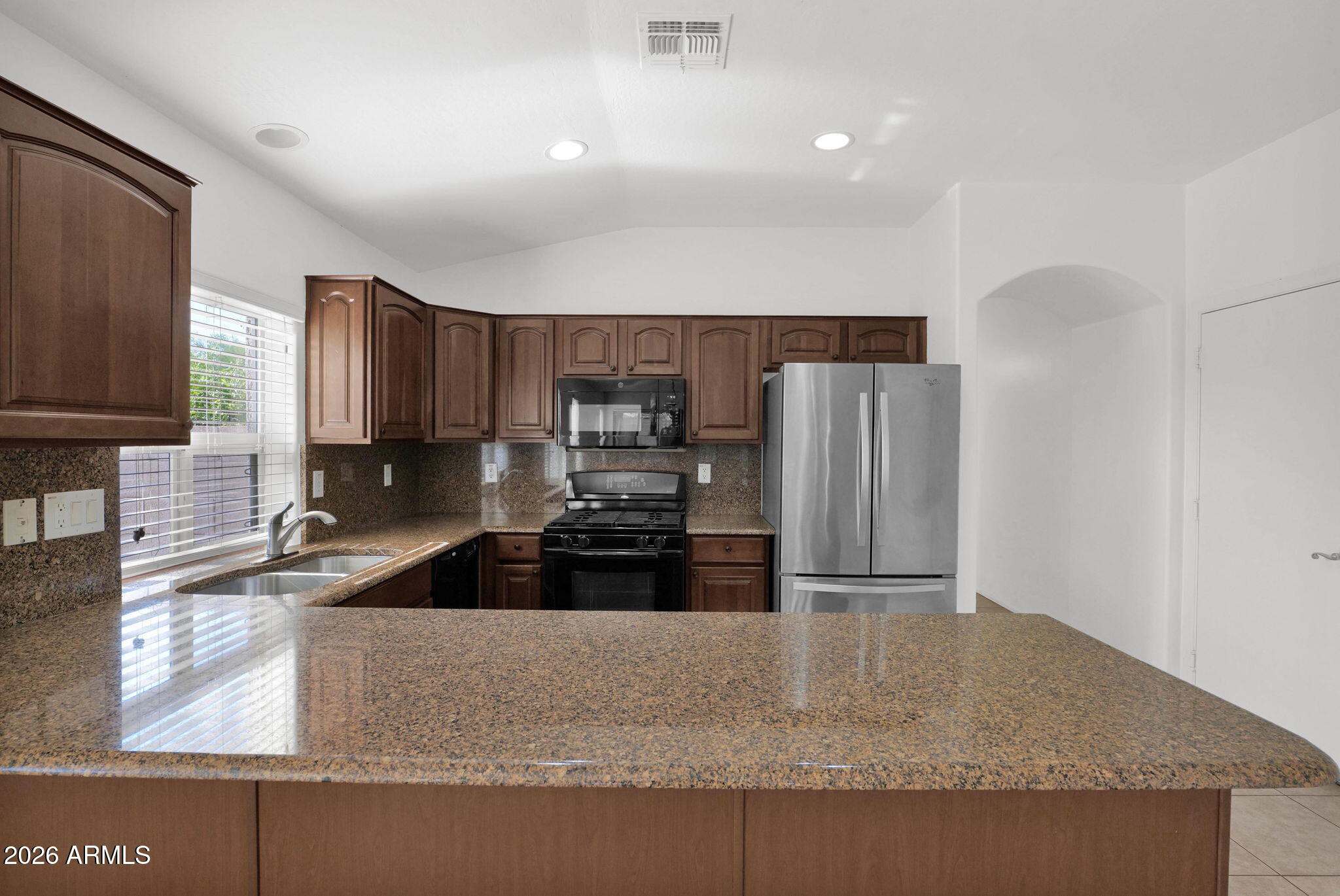 2730 East Dry Wood Road Phoenix, AZ 85024 - Photo 7 of 33 a kitchen with granite countertop a refrigerator and a sink