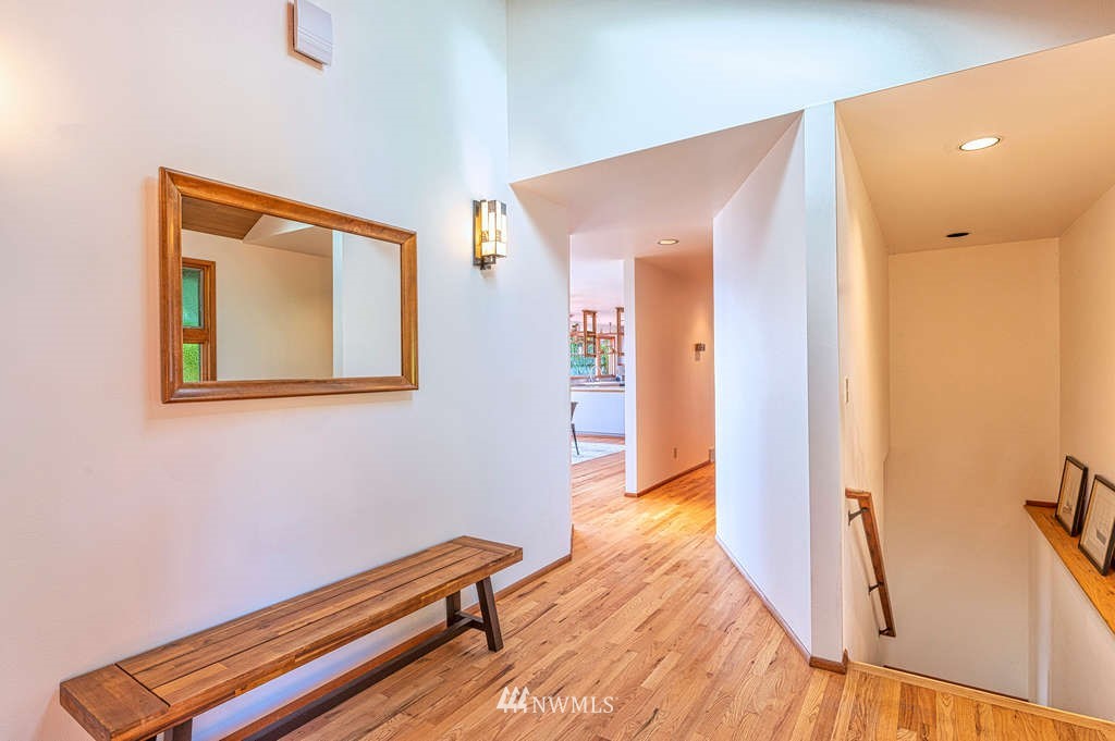 19038 Ridge Road Southwest Vashon, WA 98070 - Photo 21 of 38 a hallway with sliding door and wooden floor