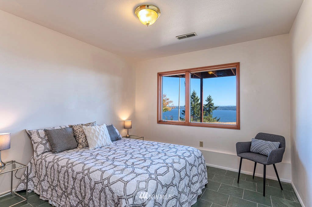 19038 Ridge Road Southwest Vashon, WA 98070 - Photo 26 of 38 a bedroom with a bed and a window