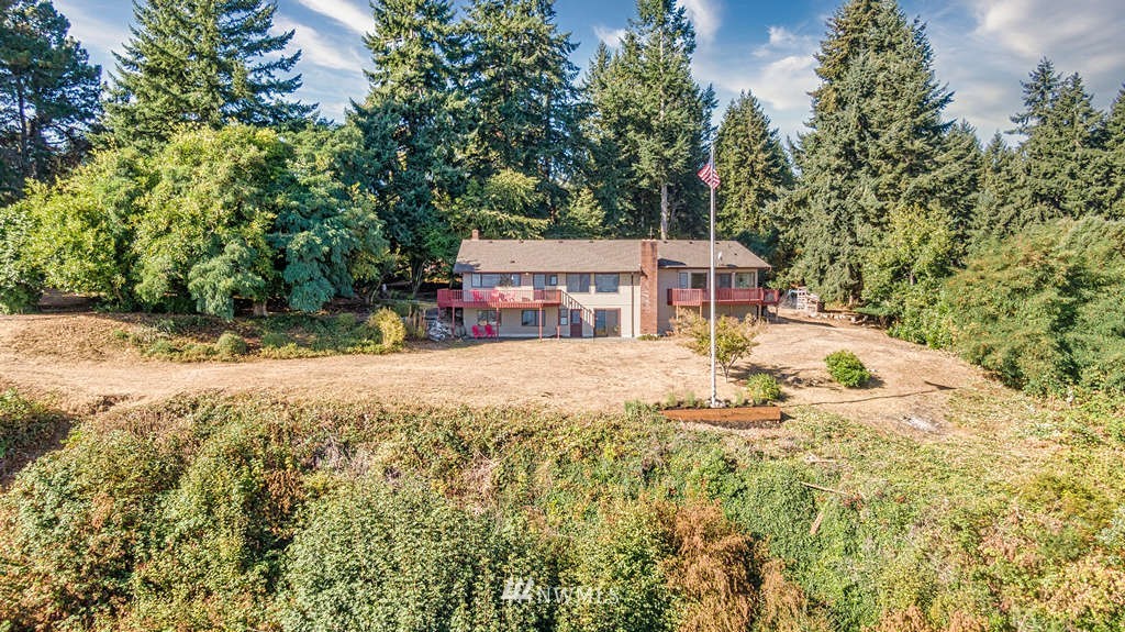 19038 Ridge Road Southwest Vashon, WA 98070 - Photo 36 of 38 a view of house with yard and trees in the background