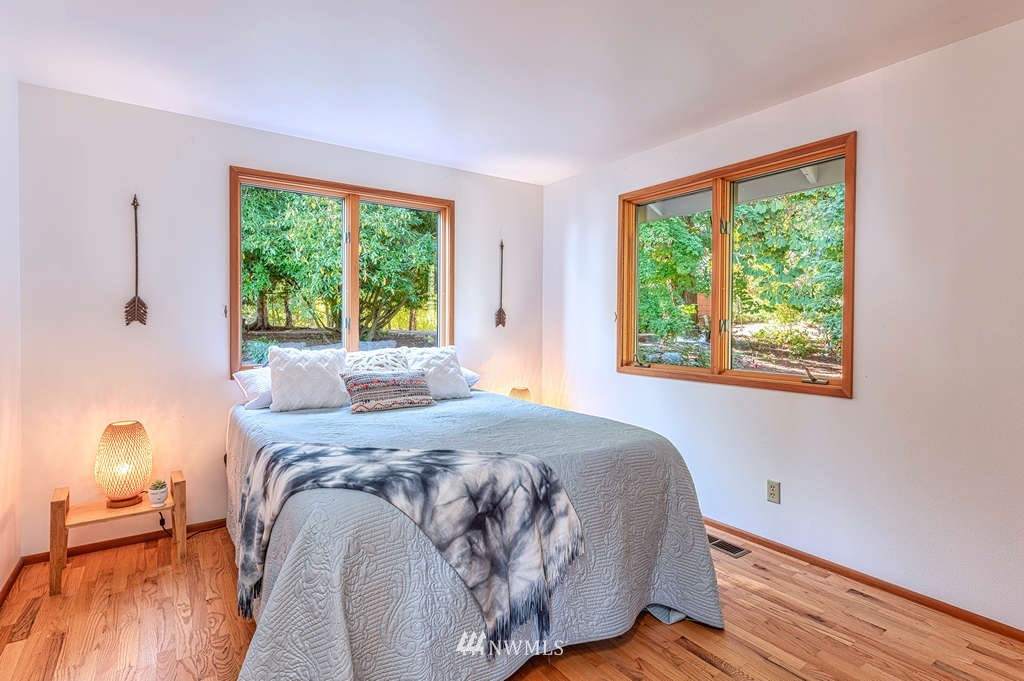 19038 Ridge Road Southwest Vashon, WA 98070 - Photo 9 of 38 a bed sitting in a bedroom next to a window