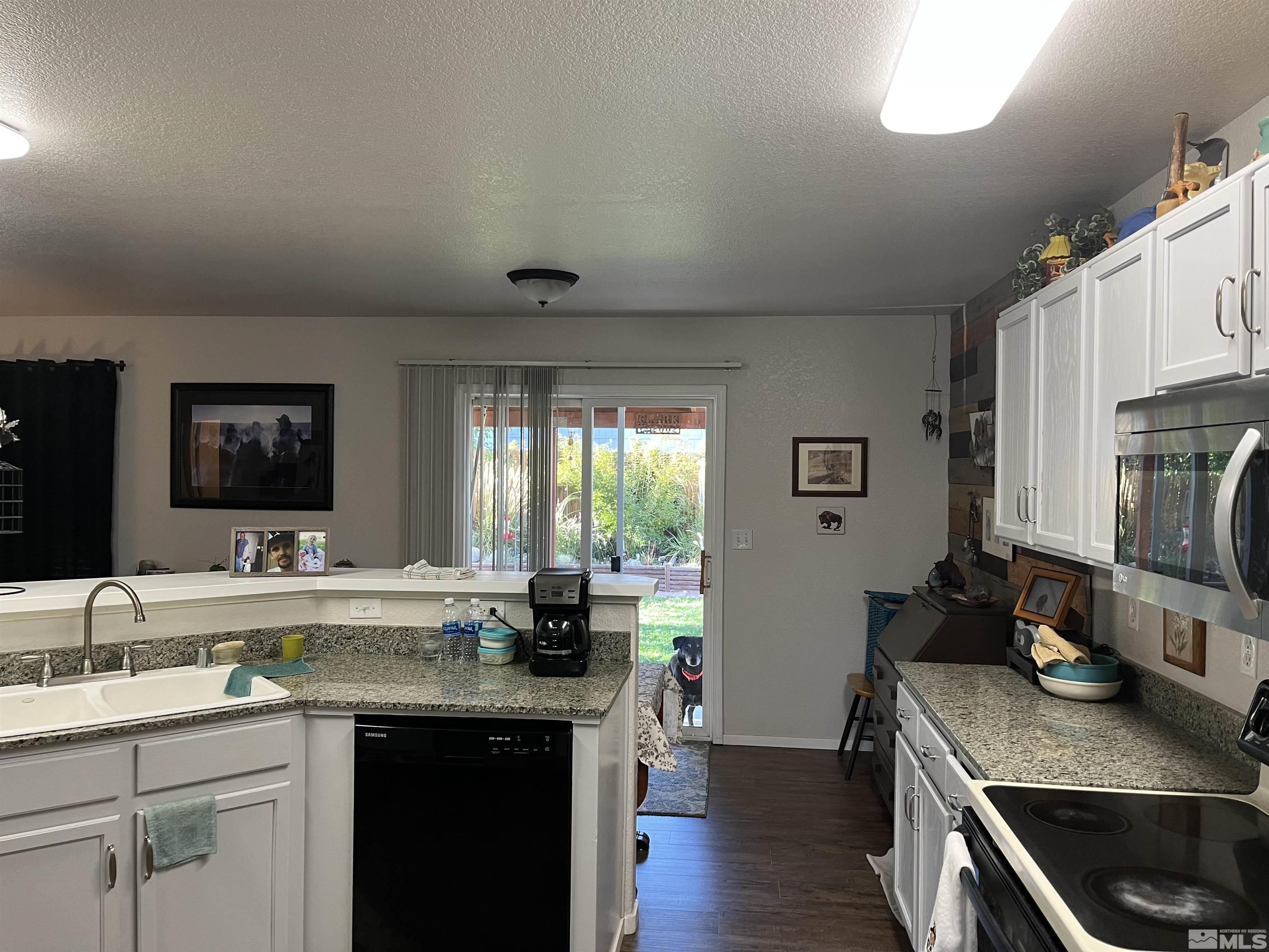7871 Tulear Street Reno, NV 89506 - Photo 8 of 29 a kitchen with sink cabinets and wooden floor