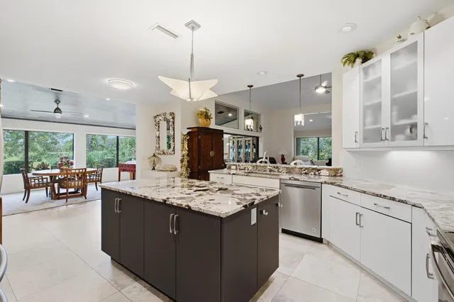a dining room with furniture a chandelier and wooden floor