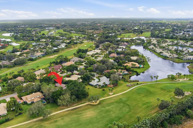 an open kitchen with stainless steel appliances kitchen island granite countertop a table chairs in it and wooden floors