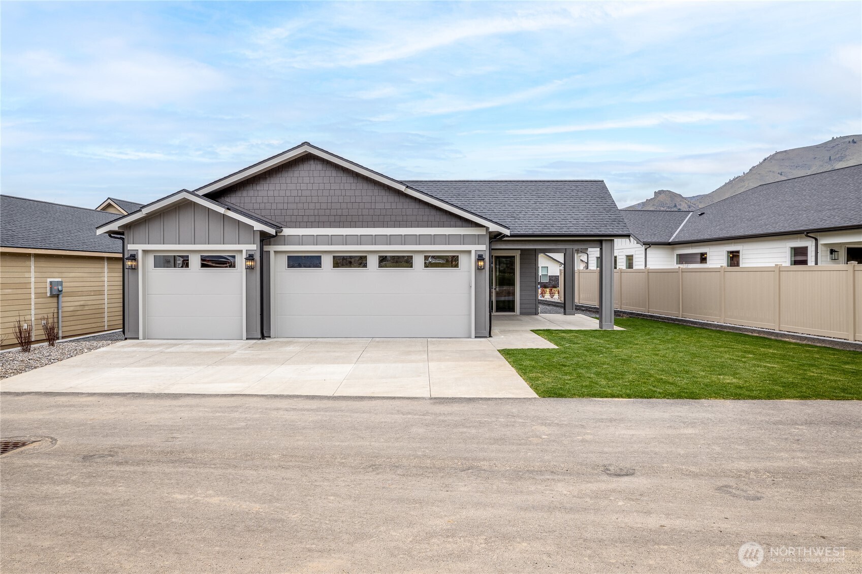 914 Racine Spgs Drive Wenatchee, WA 98801 - Photo 16 of 18 a front view of a house with a yard and garage