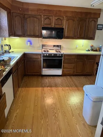a kitchen with a sink a stove and cabinets
