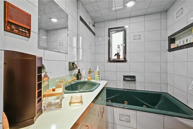 a kitchen with a sink a refrigerator and cabinets